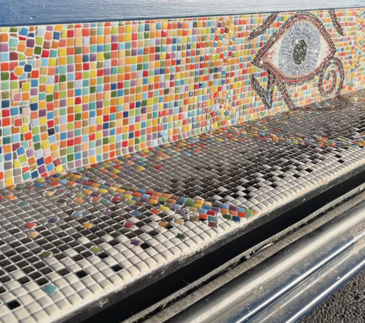 Angled view of the bench showing the Eye of Horus beside a rainbow tile grid