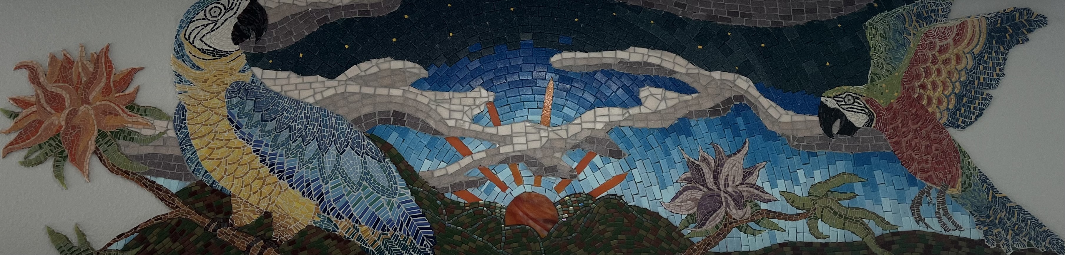 Detail of a mosaic panorama titled Color of Evening, showing macaws in blue, gold, and red tesserae