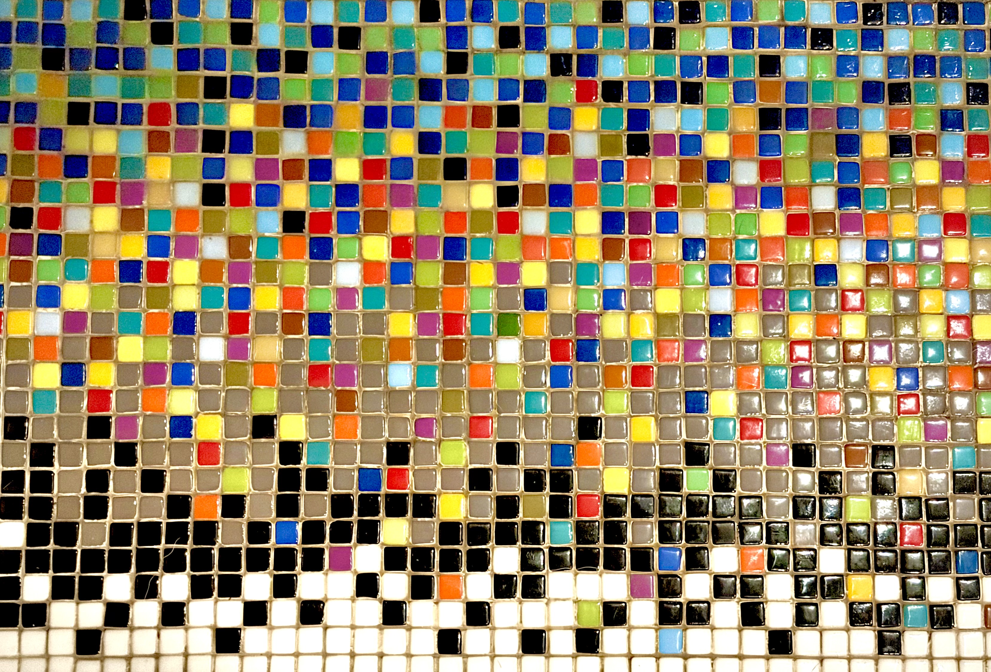 Close-up detail of the rainbow-to-black-and-white tile grid surface adjoining Depth